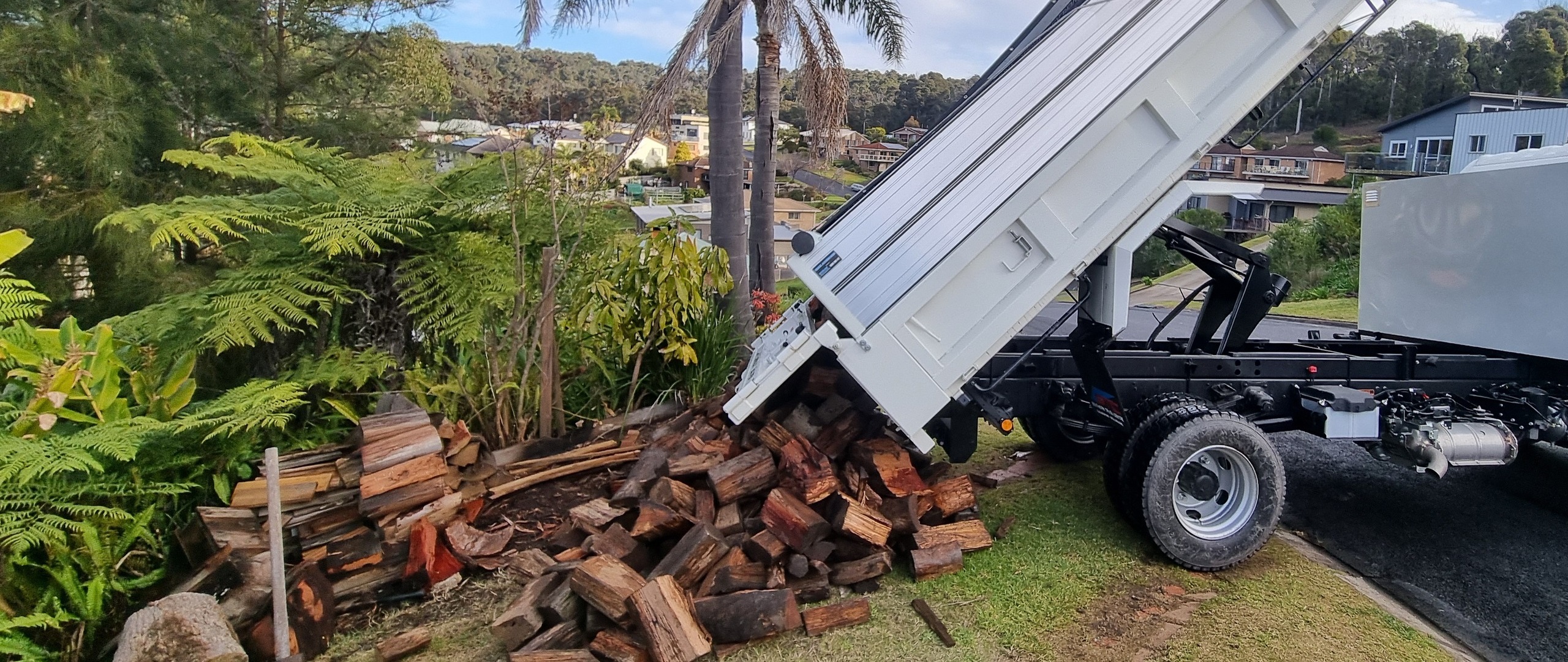 Stafford’s tipper truck unloading firewood at a winner’s property.