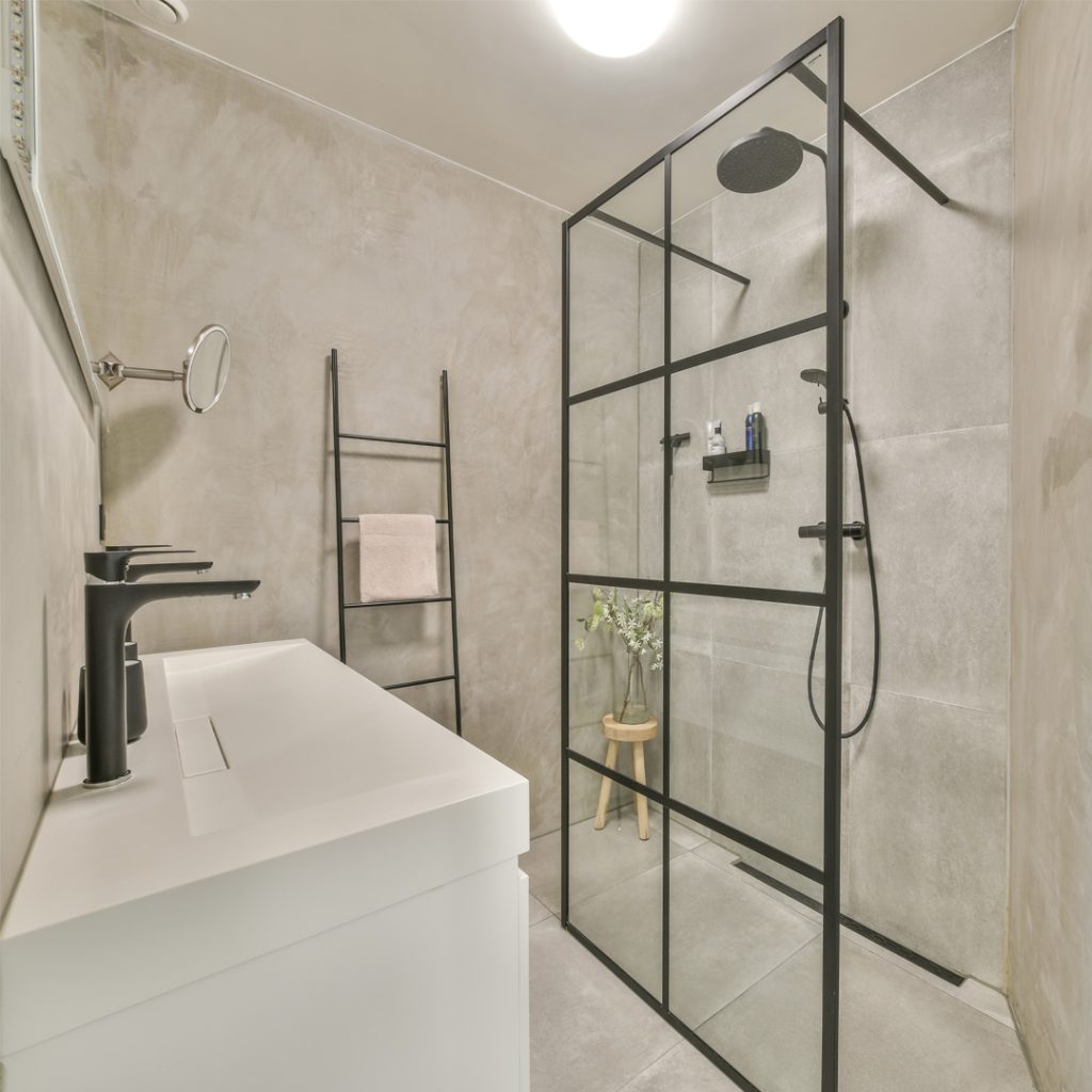 A stylish bathroom featuring a black-framed shower screen, blending timeless elegance with modern design.